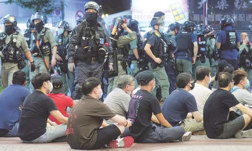 Hong Kong makes first security law arrests as thousands defy protest ban