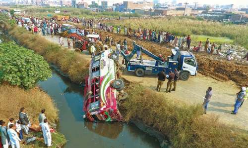 Three killed as bus falls into drain