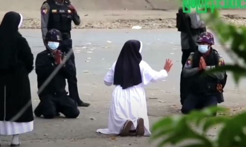 Nun kneels in front of police to stop Myanmar violence, but in vain Nun kneels in front of police to stop Myanmar violence, but in vain