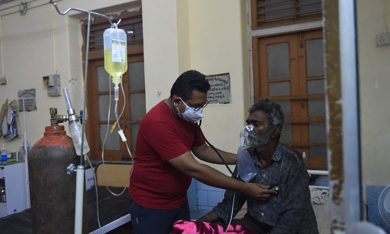 India's Covid tally passes 25 million as cyclone complicates efforts in Modi's state