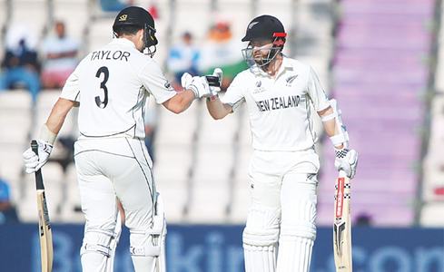 NEW ZEALAND captain Kane Williamson (R) and batting partner Ross Taylor touch gloves during the last day of the World Test Championship final.—AP