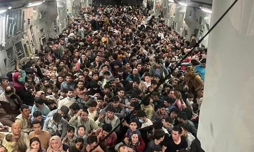 Over 600 fleeing Afghans cram into dramatic US military flight