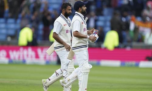 Pujara, Kohli hold firm to keep England at bay