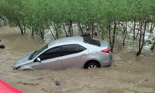 Flooded roads and traffic jams as torrential rain hits parts of Karachi