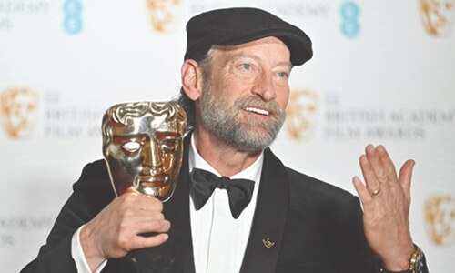 Troy Katsur, who is deaf, poses with the award for best supporting actor.&mdash;AFP