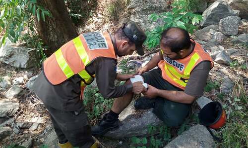 A rescue worker treats another's leg, who was injured while trying to douse the fires.—Photo provided by author