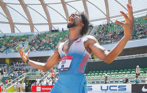 World champ Lyles overcomes teenager Knighton