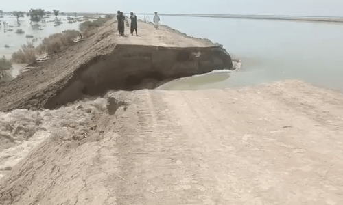 Gushing floodwaters burst through Main Nara Valley Drain near Dadu district