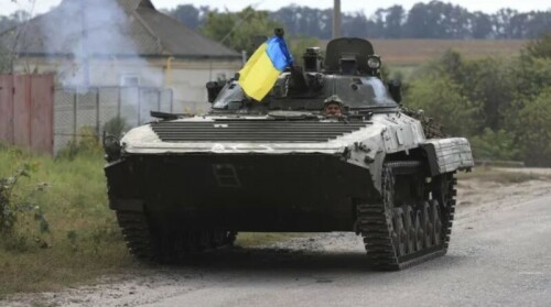 Ukraine troops raise flag over railway hub as advance threatens to turn into rout