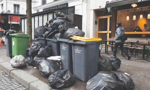 Garbage piles up in Paris as Macron vows to push through pension reform