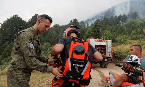 Kosovo man braves wildfires on motorbike to deliver water to firefighters Kosovo man braves wildfires on motorbike to deliver water to firefighters