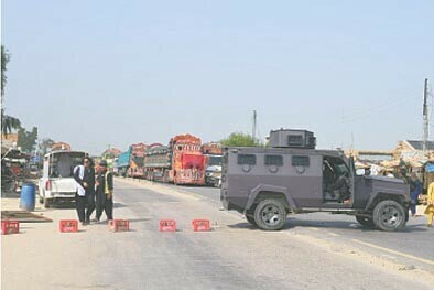 Police officials block Indus Highway in Tajazai against militant attacks