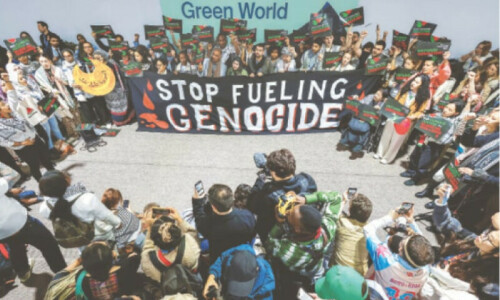 Sporting keffiyehs, climate protesters at COP29 demand end to militarisation