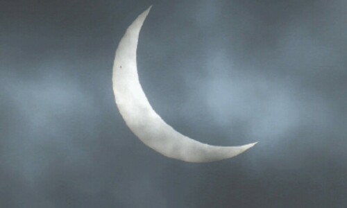 Enthusiasts in UK watch partial solar eclipse as Moon covers the Sun
