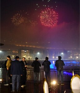 Fireworks light up drizzling capital sky