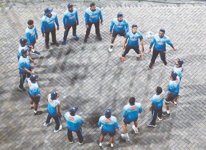 DAMBULLA: Sri Lanka players warm up during a rain delay in the second Twenty20 international match against Pakistan at the Rangiri Dambulla International Stadium on Friday. — AFP