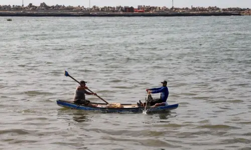 Gazan fishermen patch up dinghies with door frames to keep themselves afloat
