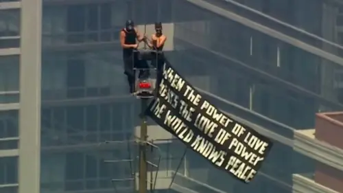 Russian daredevils unfurl banner atop New York's Empire State Building in proposal stunt