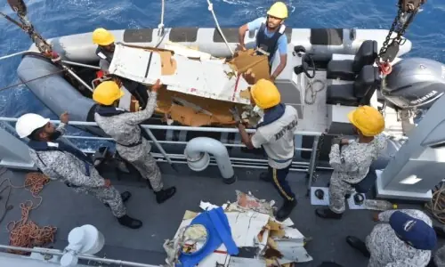 Families of crew aboard crashed cargo plane face agonising wait