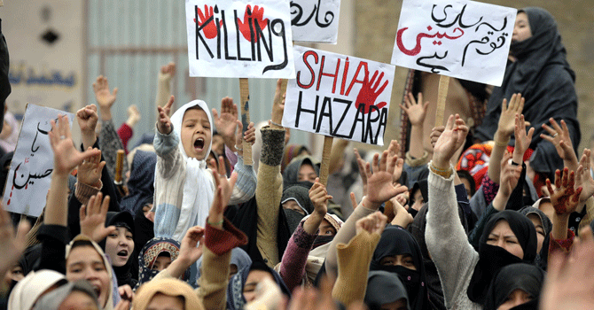 Hazaras shout slogans as they protest against the bombing which killed 89 people, in Quetta on February 18, 2013. Thousands of members of the Shia community refused for a third day on Tuesday to bury victims of a devastating bomb attack on their community, demanding protection against record levels of sectarian violence. — AFP Photo