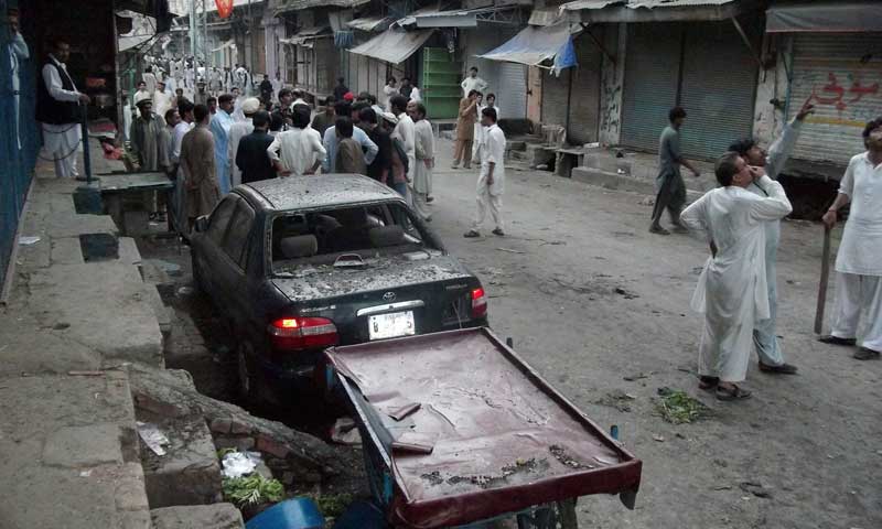 Residents gather at the site of twin bomb explosions in Parachinar, the main town of Kurram tribal district, July 26, 2013. — Photo by AFP