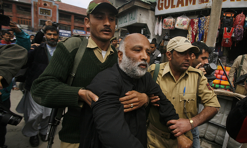 Indian Policemen detain an activist of The All Parties Hurriyat Conference, an umbrella group of separatists, outside a hotel in Srinagar, India.—Photo by AP