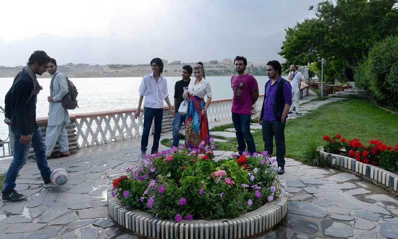 In this photograph taken on July 12, 2013, Afghan female singer Aryana Sayeed (3rd R) walks with contestants from The Voice of Afghanistan television show at Qargha lake on the outskirts of Kabul. &mdash; Photo by AFP