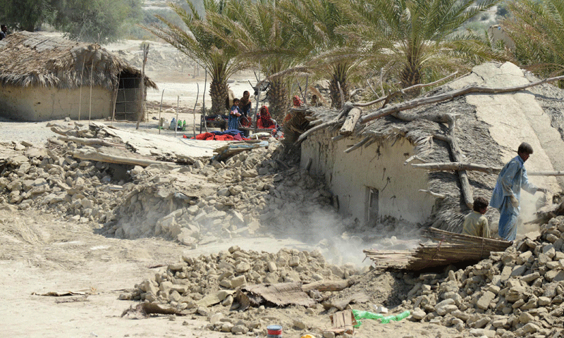 Earthquake survivors search through the debris of their collapsed houses in the devastated district of Awaran – Photo by AFP