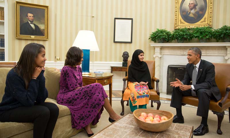 This official White House photo showsPresident Barack Obama, First Lady Michelle Obama, and their daughter Malia meet with Malala Yousufzai, the young Pakistani schoolgirl who was shot in the head by the Taliban a year ago, in the Oval Office, October 11, 2013. — Photo by AFP