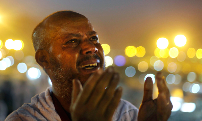 An Egyptian Muslim pilgrim cries as he prays at sunrise at Mount Arafat.—AP Photo