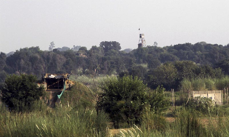 An Indian security picket (L) and a Pakistani security watch tower (R) are pictured along the border between India and Pakistan in Samba sector.  — File Photo by Reuters