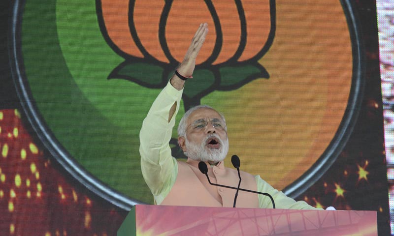 Party symbol Lotus is projected behind as India's main opposition Bharatiya Janata Party's prime ministerial candidate Narendra Modi addresses a rally in Patna, Oct 27, 2013. — Photo by AP