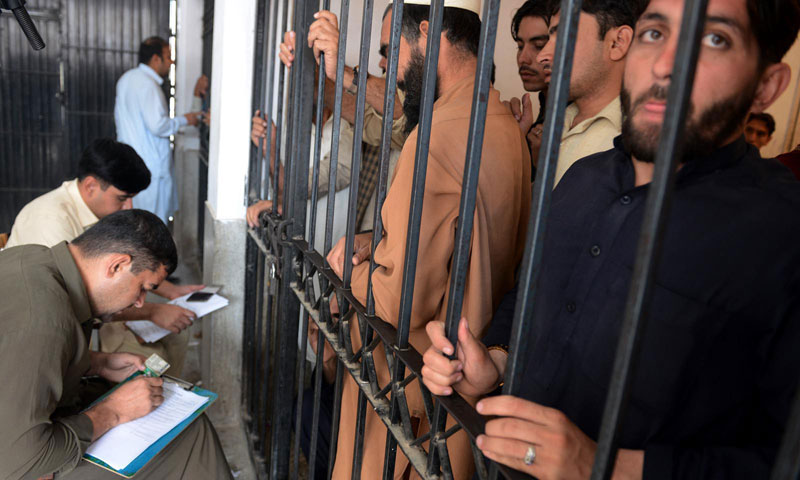 Police officials register the names of suspected persons during search operations in Peshawar. — Photo by INP