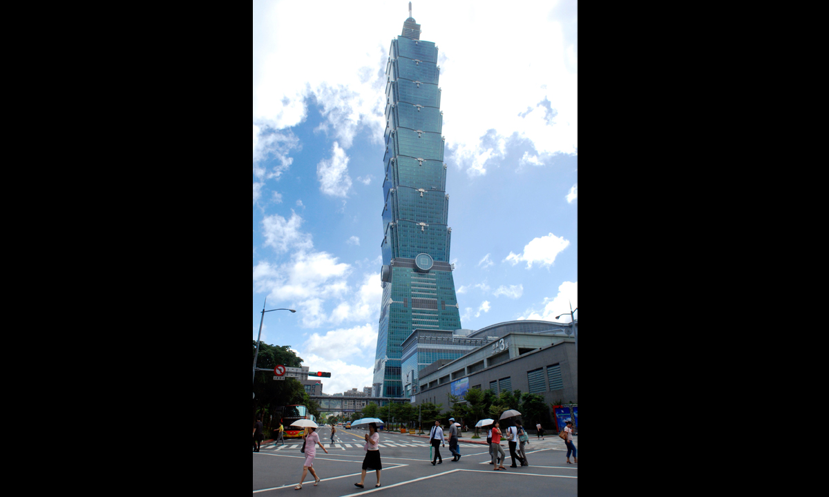 Pedestrians cross a road by the side of Taipei 101 in Taipei. Taiwan. – Photo by AP