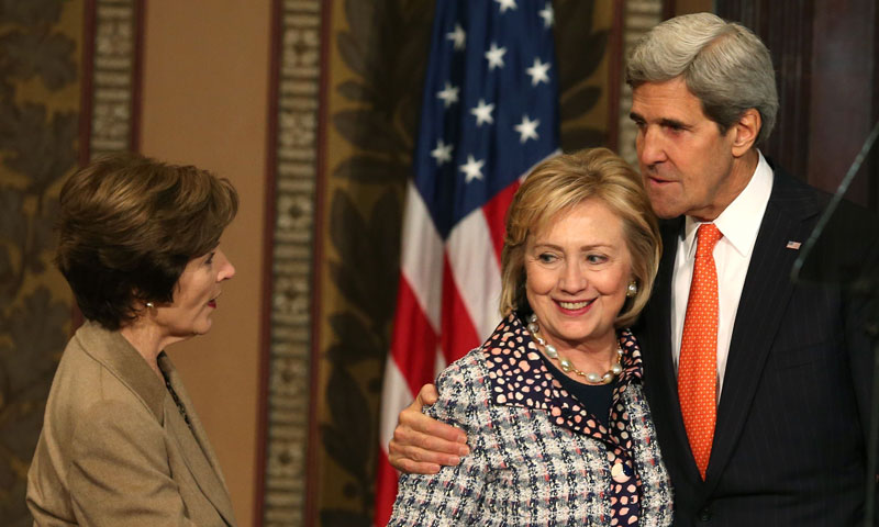 Former Secretary of State Hillary Clinton (C), Secretary Of State John Kerry and former first lady Laura Bush stand together during an event to honor the women of Afghanistan, at Georgetown University, November 15, 2013 in Washington, DC. — Photo by AFP