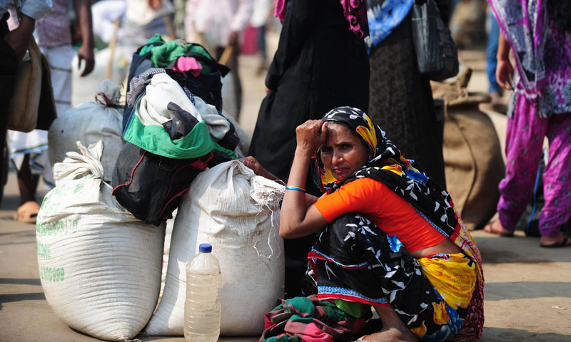 A Bangladeshi commuter waits at a bus terminal during a blockade organised by Bangladesh Nationalist Party activists and their supporters in Dhaka on November 30, 2013. — Photo by AFP