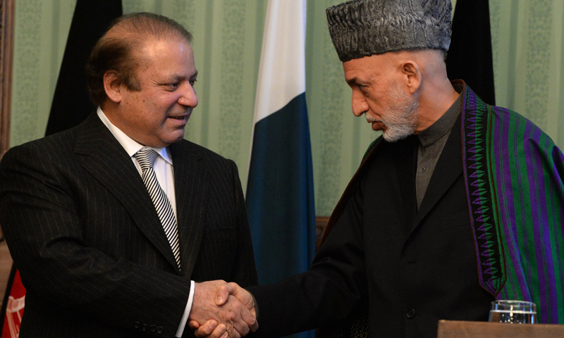 Prime Minister Nawaz Sharif shakes hands with Afghan president Hamid Karzai (R) at the Presidential Palace in Kabul on Nov 30, 2013.—AFP Photo