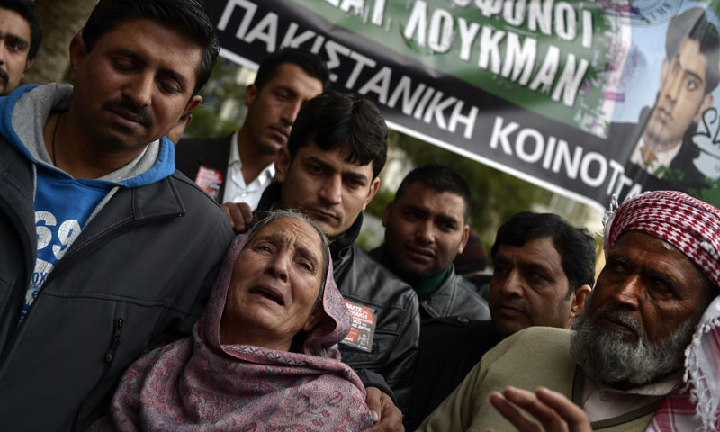 The mother of Shehzad Luqman reacts as she leaves an Athens court where two suspected members of the Greek neo-Nazi party Golden Dawn accused of her son's murder are being judged on December 18, 2013. – AFP