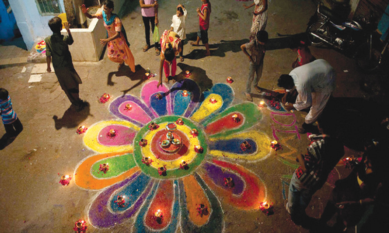 Members of the Pakistani Hindu community make a rangoli during Diwali celebrations in Karachi. 	— Reuters