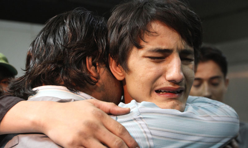 Family members mourn the deaths of local news channel employees at a hospital in Karachi, Pakistan, Friday, Jan. 17, 2014. — Photo by AP