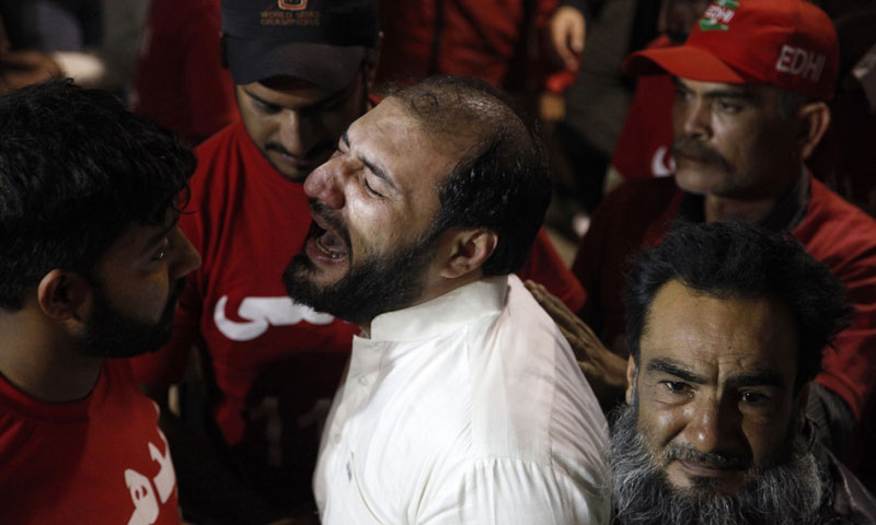 A brother of a slain religious cleric cries at a local hospital in Karachi, Pakistan, Friday, Jan. 17, 2014. — Photo by AP