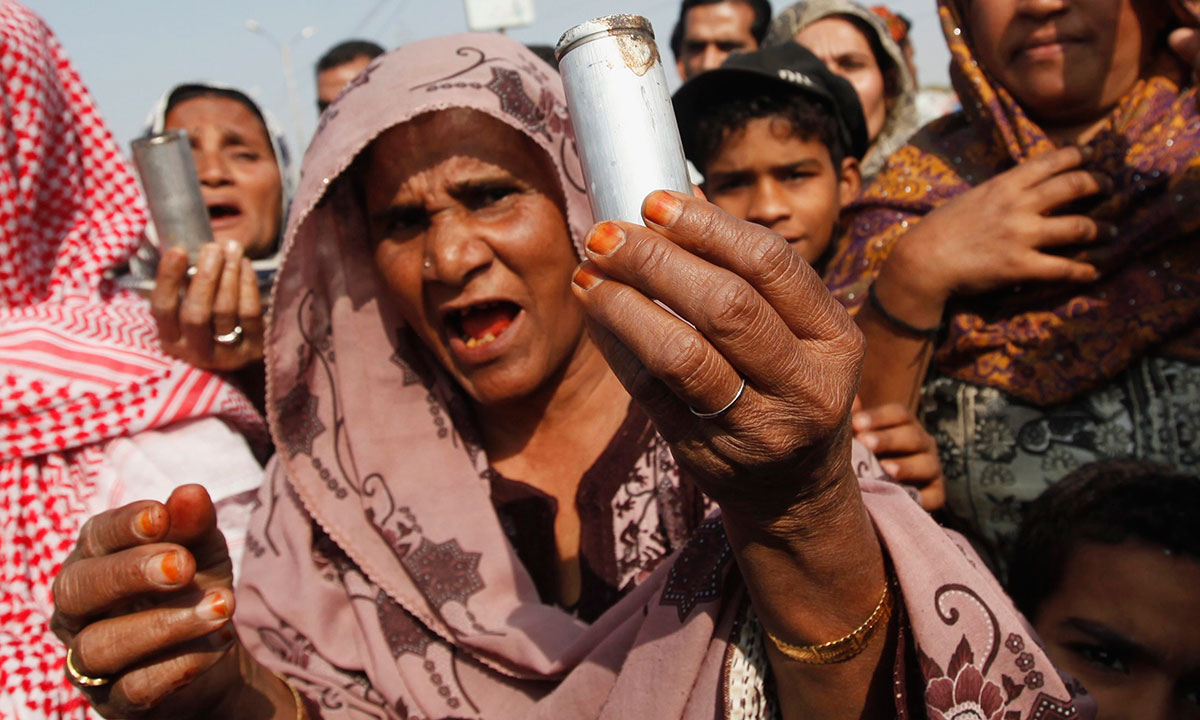 Residents display empty tear gas shells fired by the police, to members of the media, during a road block protest against a search operation, after the killings of three polio vaccination workers on Tuesday, in Karachi January 22, 2014. Police arrested more than 100 suspects after three polio eradication workers, including two women, were shot dead by armed men on motorcycles during a vaccination drive on Tuesday in Qayyumabad, eastern Karachi, local media reported.  – Photo by Reuters