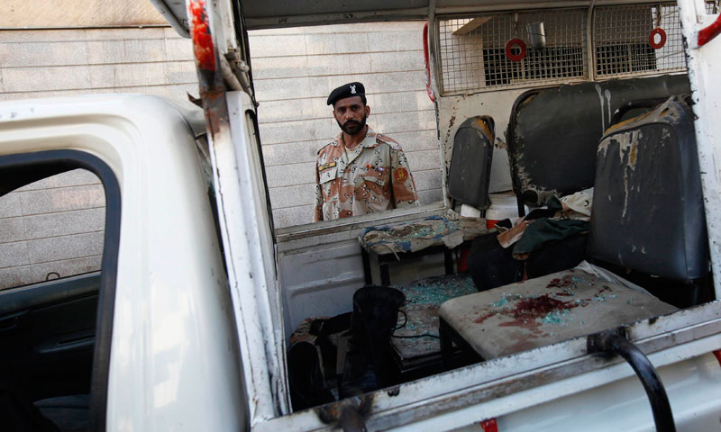 A Rangers soldier stands near a vehicle, with blood stains on a seat, after a bomb attack in Karachi January 29, 2014.—Reuters Photo