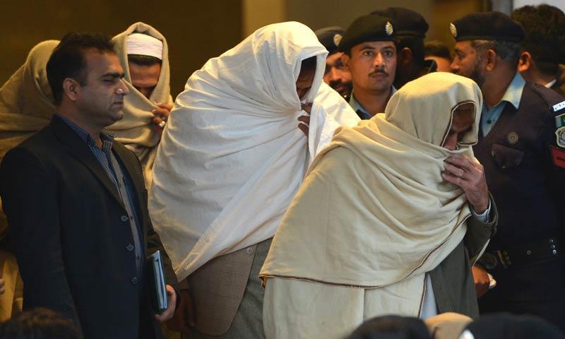 Policemen escort missing persons following an identification process as they leave the Supreme Court building in Islamabad. – AFP Photo/File