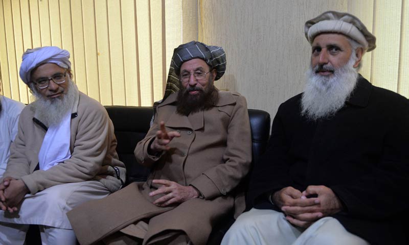 Chief cleric of Islamabad's Red Mosque, Maulana Abdul Aziz (L) and two senior religious party leaders, Maulana Samiul Haq (C) and Professor Mohammad Ibrahim, sit together after a meeting in Islamabad, Feb 3, 2014. The three are members of the Taliban-nominated committee set up to hold peace talks with the government's committee. — Photo by AFP