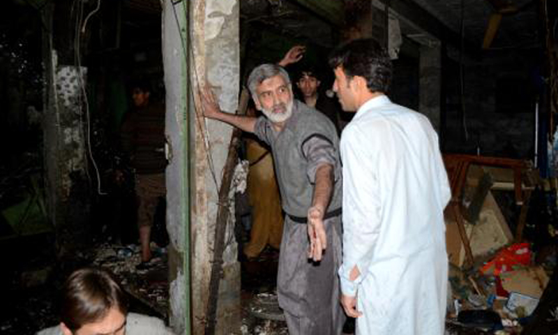 People inspect site of the suicide bombing in Peshawar on Tuesday night. – Photo by Zahir Shah Sherazi