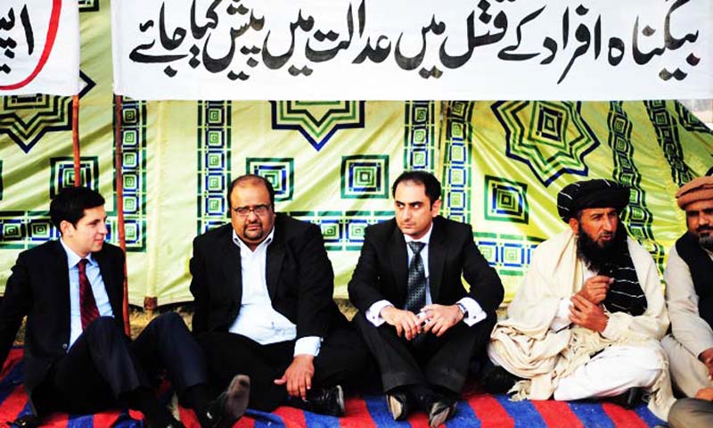 Kareem Khan (2R) and his lawyer Mirza Shehzad Akbar (2L) attend a protest against US drone attacks, in front of parliament in Islamabad on December 9, 2010. — File Photo by AFP