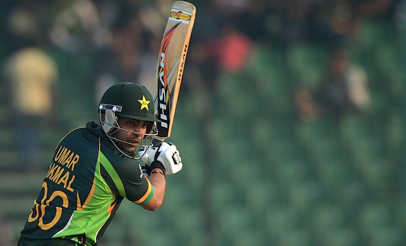 Pakistan batsman Umar Akmal (R) plays a shot  2014. -Photo by AFP