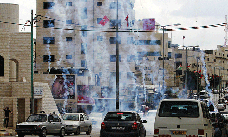 Tear gas fired by Israeli soldiers engulfs a street during clashes with Palestinian protestors sparked by the killing of Palestinians in the West bank and Gaza by the Israeli army, in West bank city of Bethlehem on March 11, 2014. — Photo by AFP