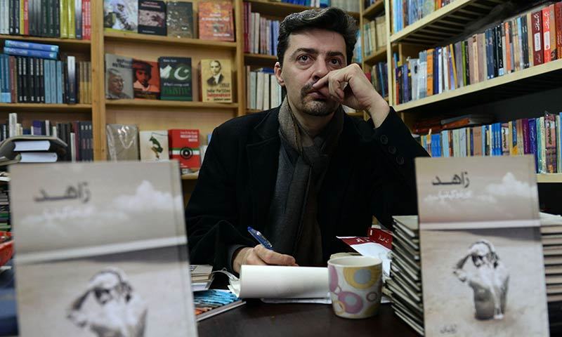 In this photograph taken on January 20, 2014 Frenchman Julien Columeau sits in a book store in Lahore. -AFP Photo